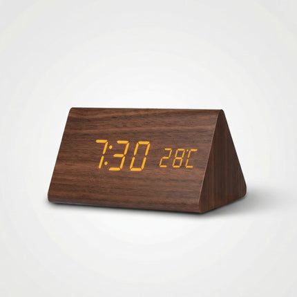 Wooden triangle-shaped digital clock with orange LED display on a white background